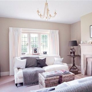 living room with white sofa and white curtains