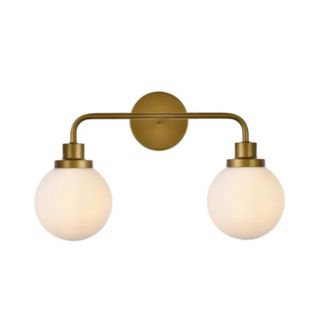 A brass dual armed wall sconce with two round bulbs