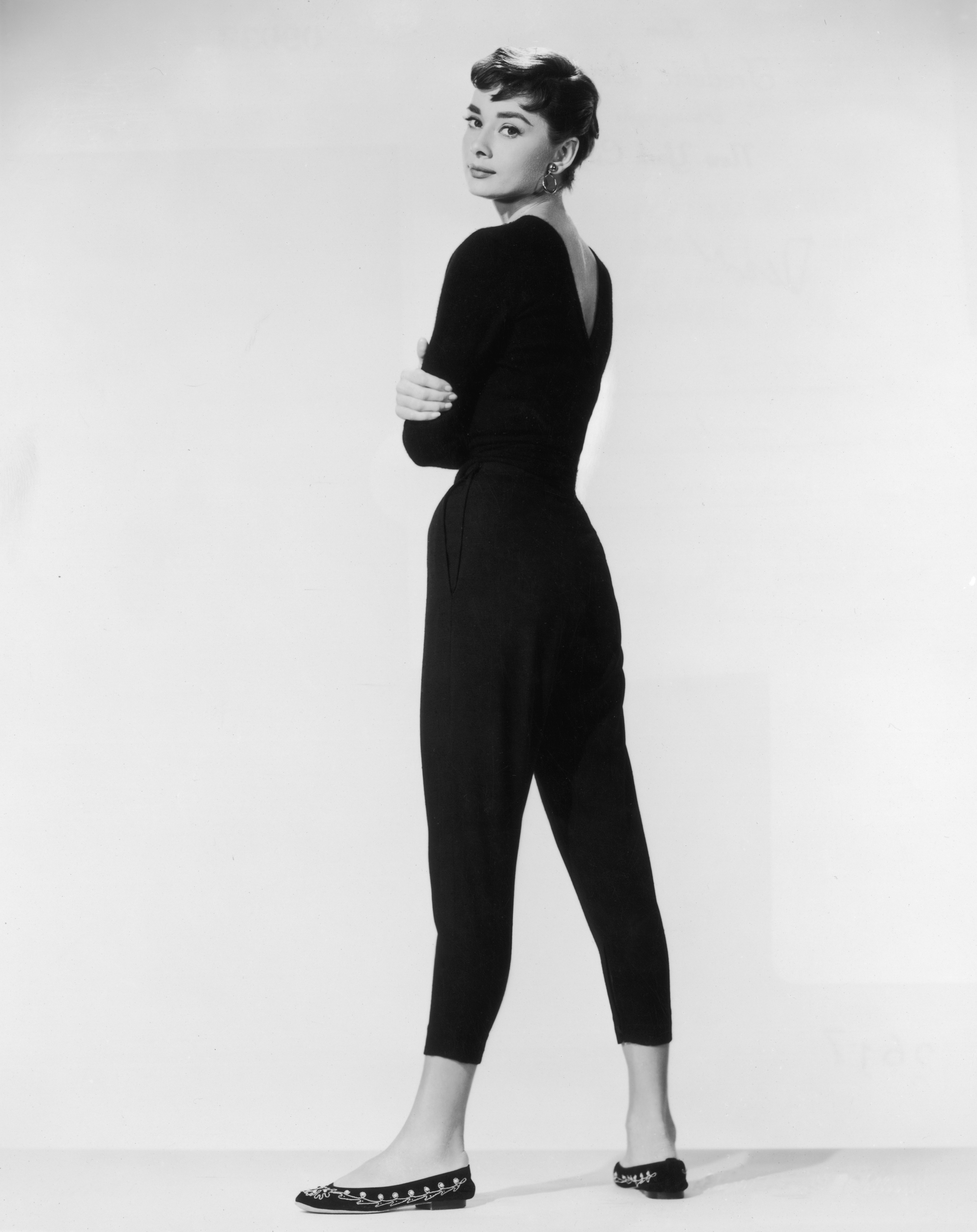 An image of Audrey Hepburn wearing pedal pushers in aromotional portrait for Billy Wilder's film 'Sabrina' in 1954.