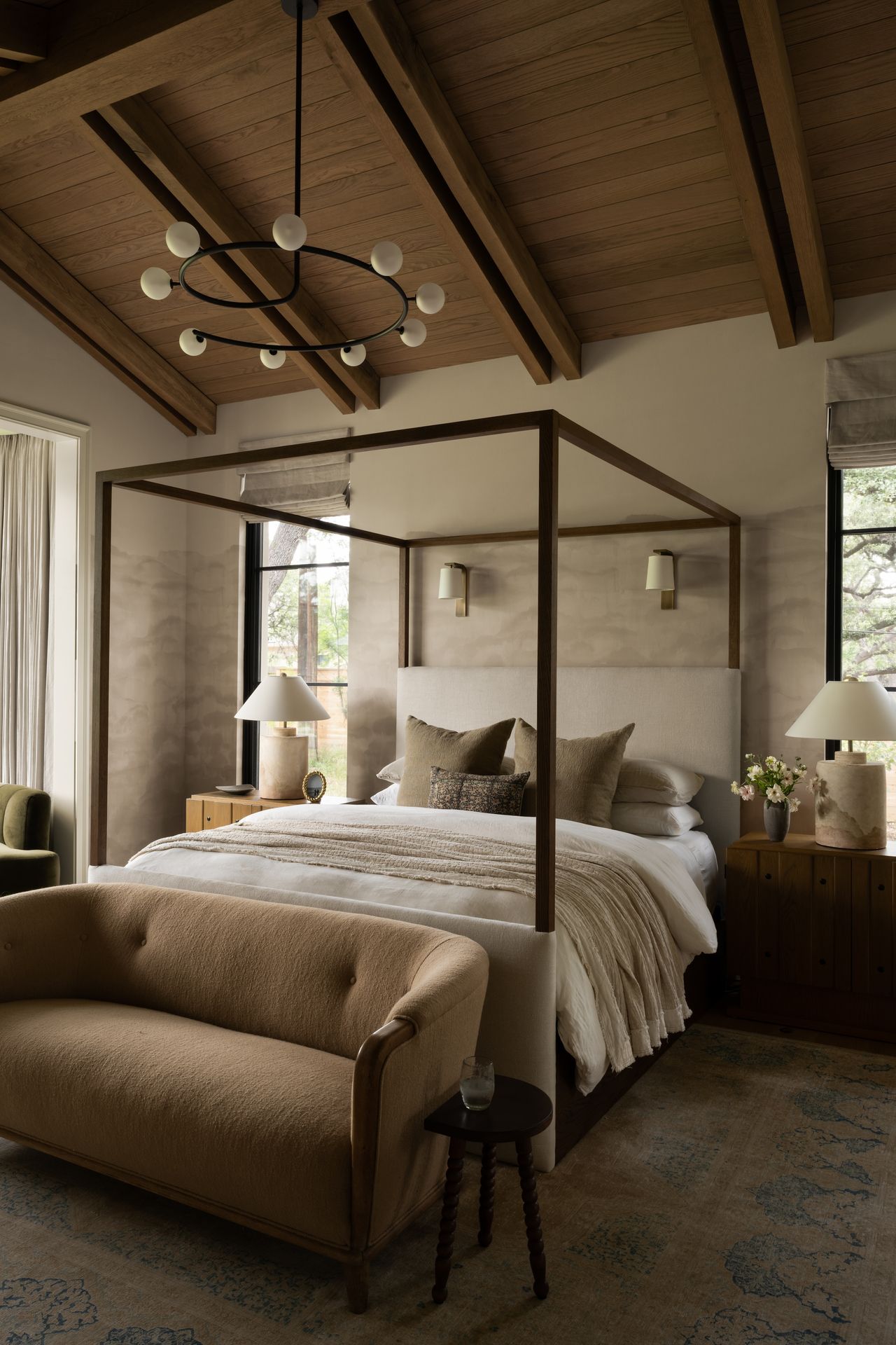 A bedroom with a four-poster bed and a neutral palette
