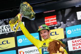 Team Bora's Slovenian rider Primoz Roglic wearing the overall leader's yellow jersey celebrates on the podium after winning the sixth stage of the 76th edition of the Criterium du Dauphine cycling race, 174,1km between Hauterives and Le Collet d'Allevard, French Alps, on June 7, 2024. (Photo by Thomas SAMSON / AFP)