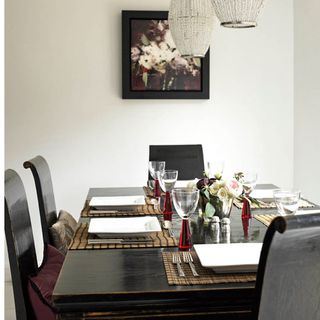 dining area with glitzy chandelier and black dining table