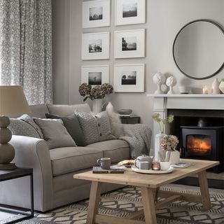 White and grey living room ideas with grey sofa and framed pictures