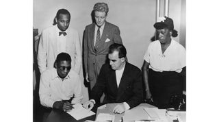 Veteran Isaac Woodard, who was beaten and blinded by police, applying for maximum disability benefits. Woodard’s mother stands at right.