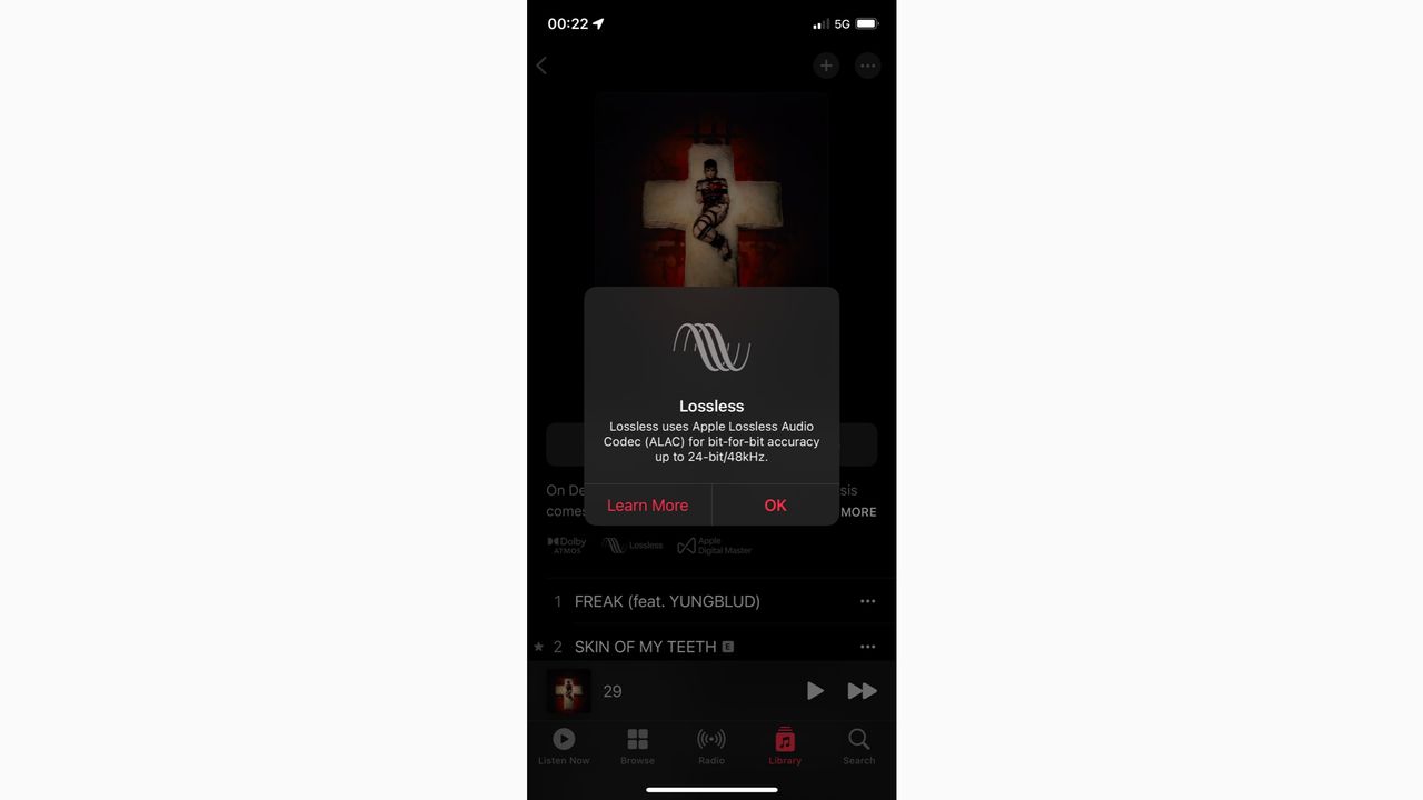 A smartphone on a white background running the Apple Music app. It is playing a lossless track.