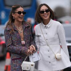 best spf moisturisers - Camila Coelho & Aimee Song seen wearing a long checkered and purple Chanel suit, white and black ballarinas, Chanel white handbag, sunglasses and a white Chanel dress, white Chanel bag, black sunglasses and white sandals outside Chanel show - gettyimages 2075791113