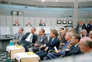 A briefing is given by Major Rocco Petrone to President John F. Kennedy during a tour of Blockhouse 34 at the Cape Canaveral Missile Test Annex.