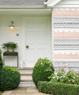 painted front door with patterned wall panel