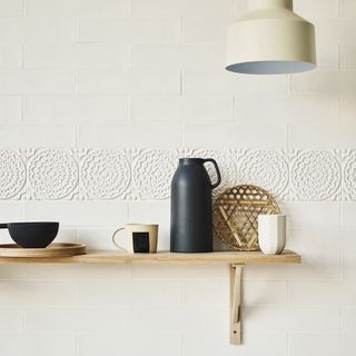 chrysanthemum patterned white wall tiles with teacup
