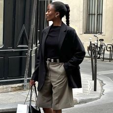 liv wears long shorts, blazer, black t-shirt, and platform chunky slides