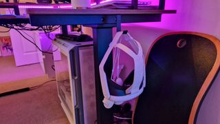 Fezibo Triple Motor L-Shaped Desk's headset hook with a Meta Quest 3 suspended from it