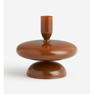 opaque brown glass candlestick with a curved design