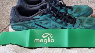 Image shows a Meglio Latex-Free Resistance Band next to running shoes.