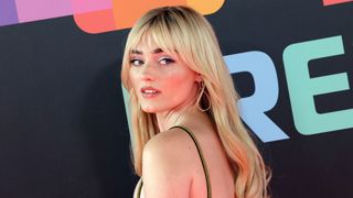 Meg Donnelly poses for photographs on the red carpet premiere for Pixar's Elemental film