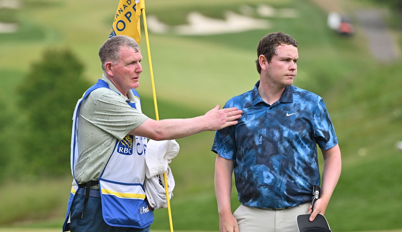 Robert MacIntyre and his dad walk off the 18th green