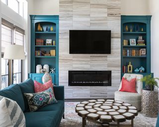 Teal living room with modern fireplace with stone tile design