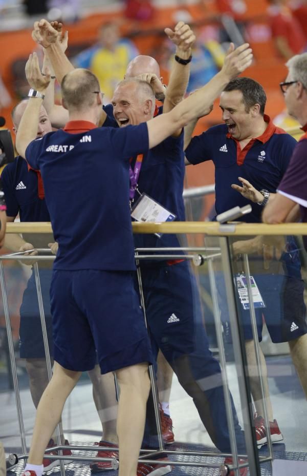 The British coaching staff enjoying gold in the men's team sprint