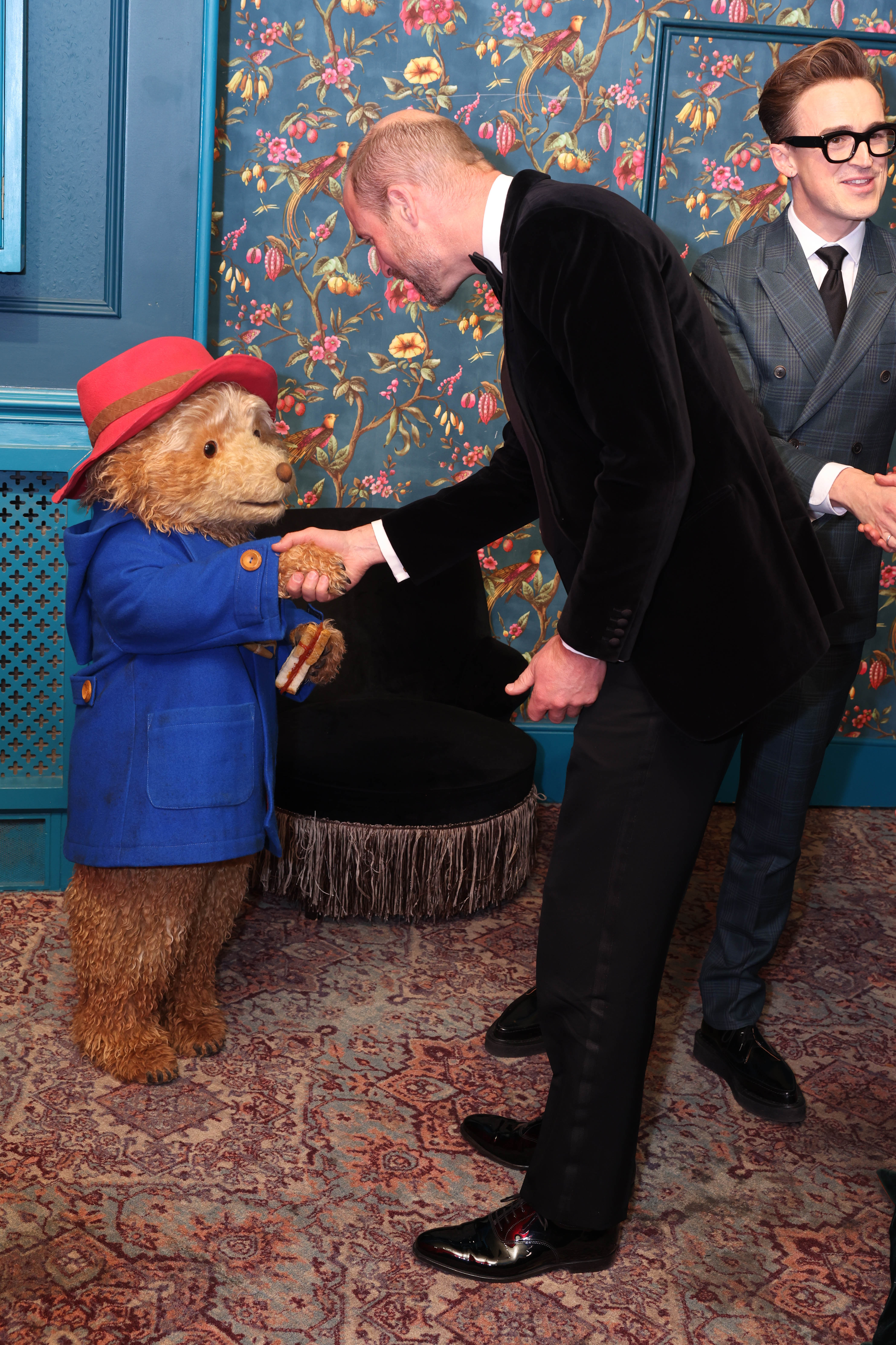 Prince William shaking hands with Paddington bear
