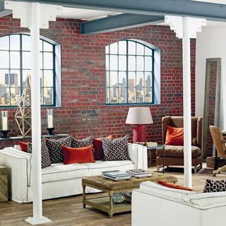 living room with white sofa and brick wall