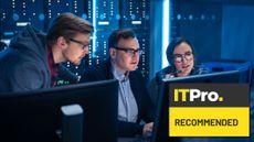 workers sharing a computer in a data centre control room