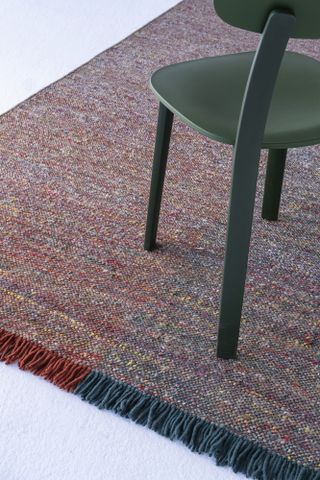 multi colored blue and red rug on a grey living room floor