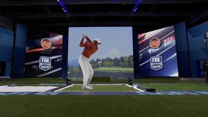 Tiger Woods hits a shot into TGL's giant screen at SoFi Center in Florida