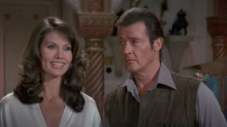 Maud Adams smiles while standing next to Roger Moore in Octopussy.