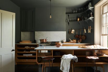 How to make the most of dead space in your kitchen; dark grey kitchen with open shelving by deVOL