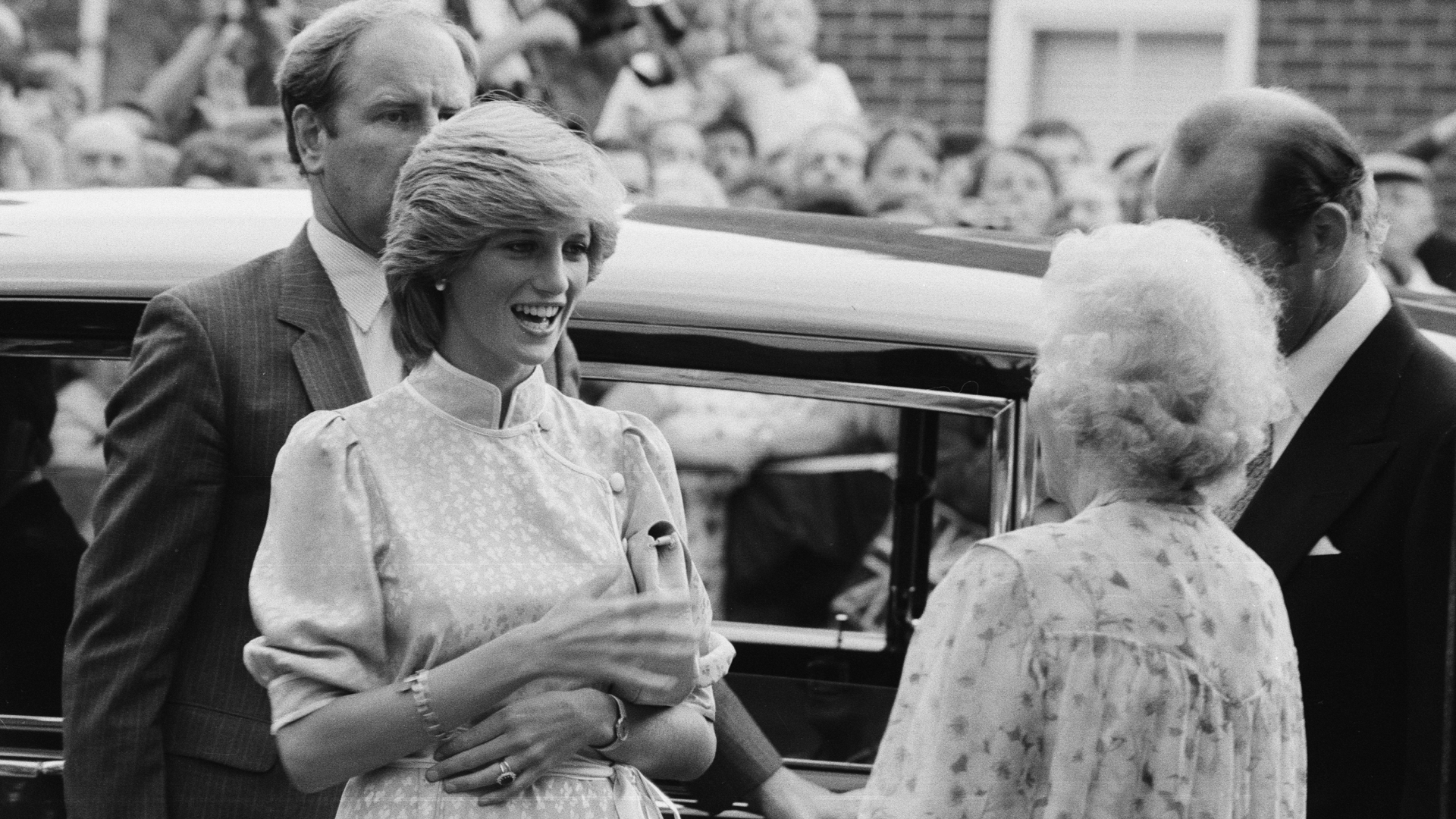 Princess Diana talking to her grandmother in front of a car