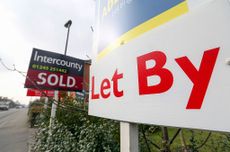 A buy-to-let property with a 'for rent' sign next to another home with a 'for sale' sign (image: Photographer: Chris Ratcliffe/Bloomberg via Getty Images)