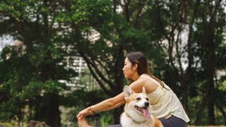 Woman doing yoga with dog