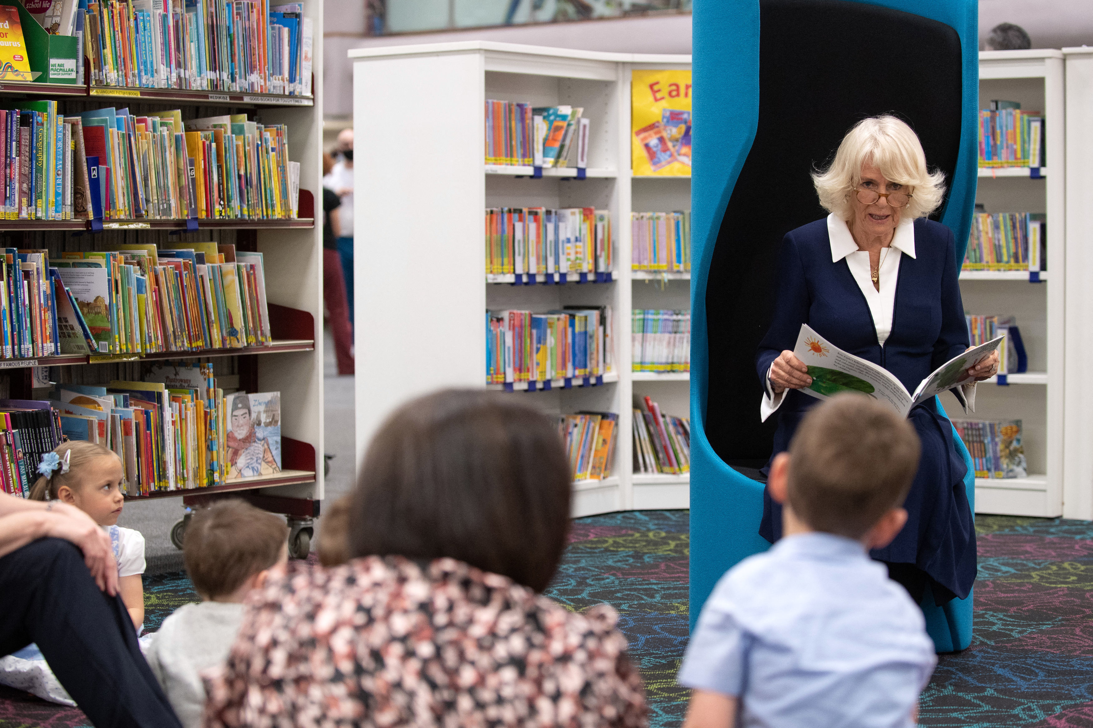 Britain&amp;amp;apos;s Camilla, Duchess of Cornwall, wearing a face covering to combat the spread of Covid-19, reads an excerpt from the book &amp;amp;apos; The Very Hungry Caterpillar&amp;amp;apos; to children during her visit to Coventry Central Library in Coventry, central England on May 25, 2021. (Photo by Joe Giddens / POOL / AFP) (Photo by JOE GIDDENS/POOL/AFP via Getty Images)