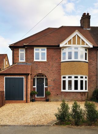 exterior of brick semi detached house with small front extension