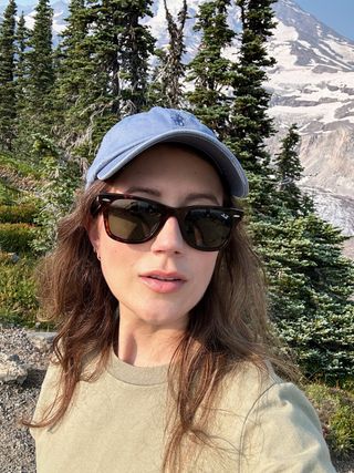 Allyson Payer wearing Ray-Ban wayfarer sunglasses and a blue baseball cap