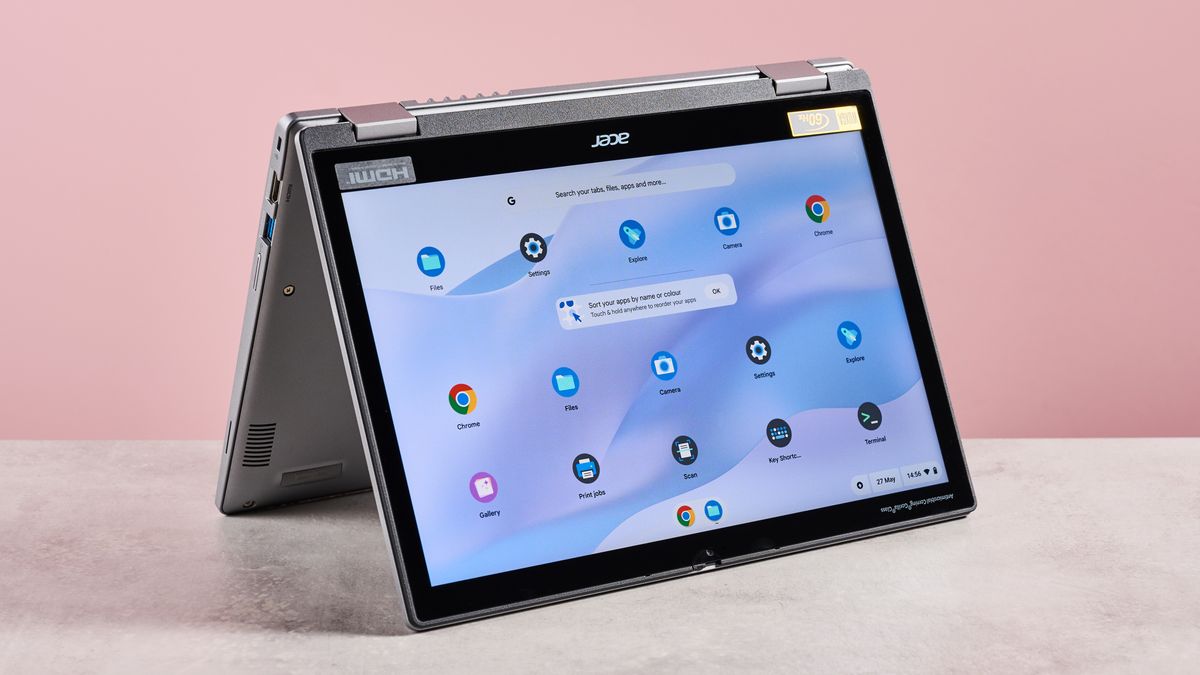 Acer Chromebook Spin 312 open upside down on desk with pink background