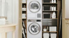shelving in cream fitted inbuilt cabinets with washing machine and tumble dryer in a laundry room design -smeg