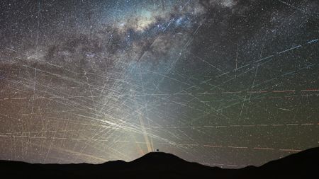 bright streaks of light crisscross through a night sky