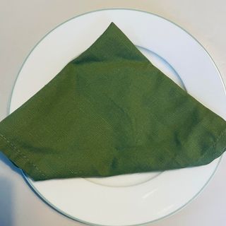 Green serviette on a white plate