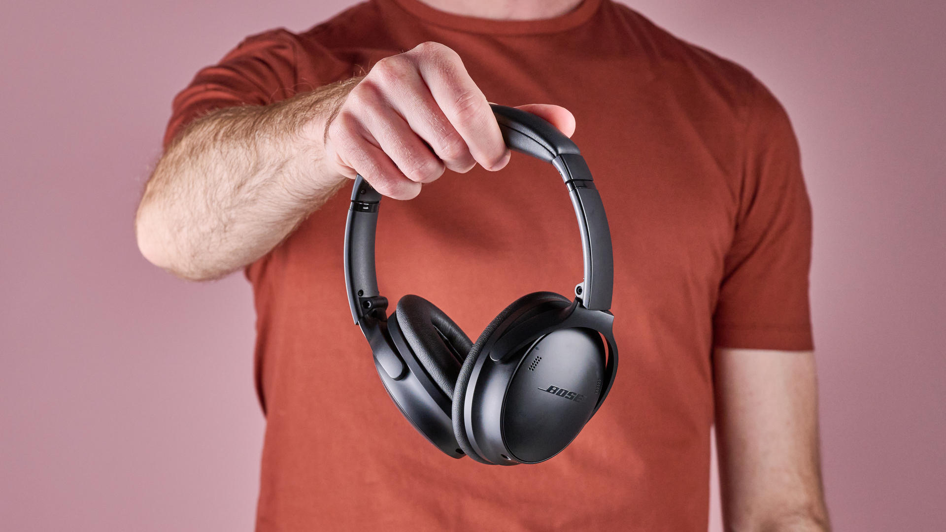 Bose QuietComfort Headphones held in a man's hands