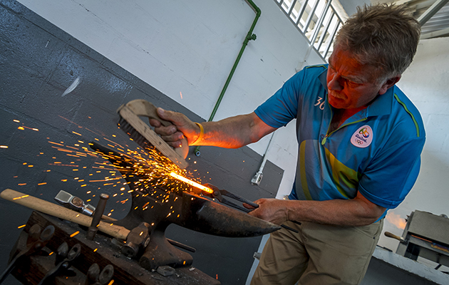 Farrier Jim Blurton finishes a shoe
