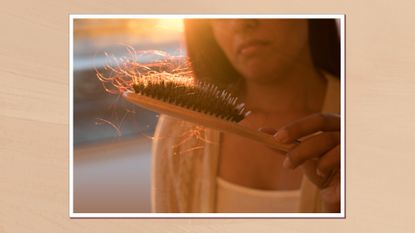 Image showing close up of woman holding a hair brush with several strands of hair in it, in a white frame against a beige watercolour-style background