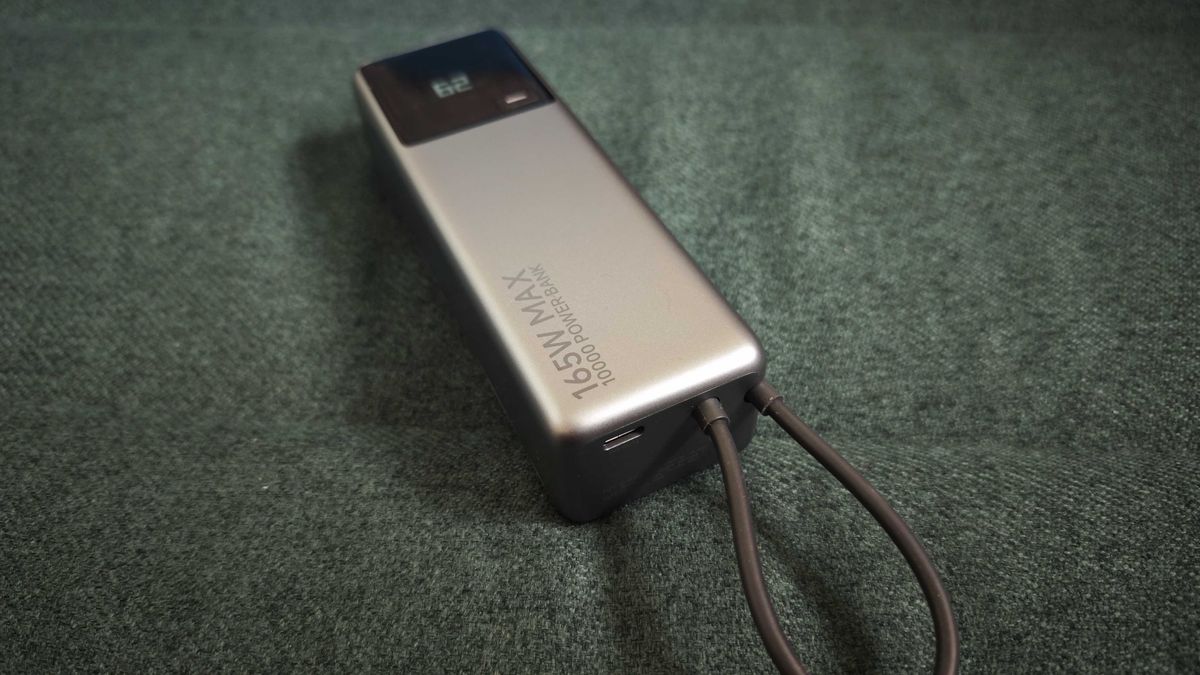 A matte grey Xiaomi 165W Power Bank on a green sofa