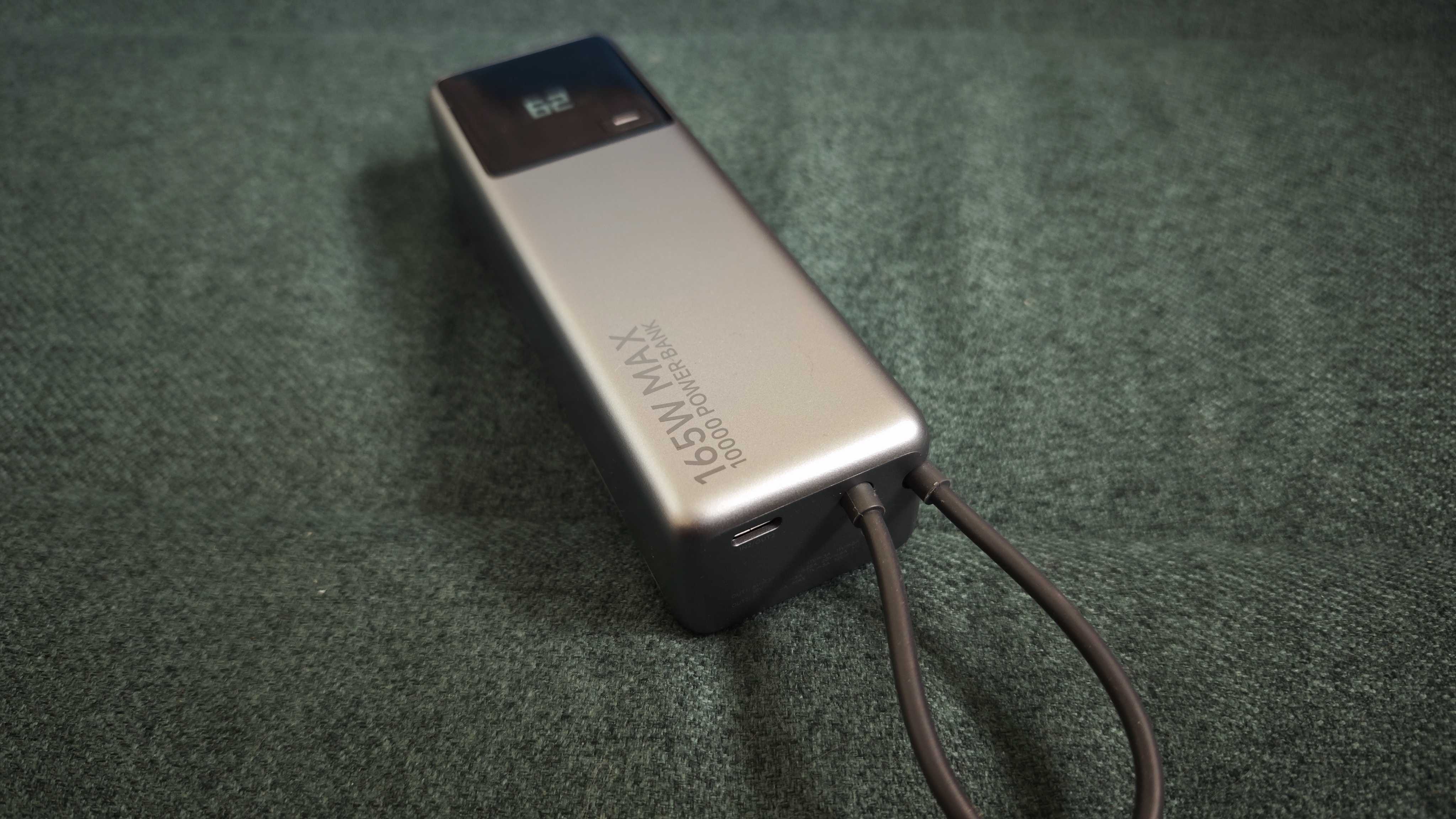 A matte grey Xiaomi 165W Power Bank on a green sofa