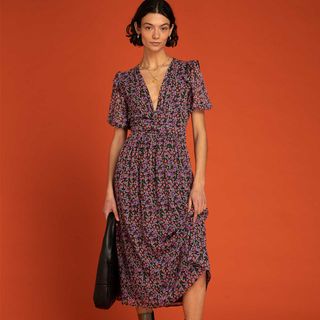 black based micro floral print midi dress, with purple floral print. The dress features a deep v-neckline and short sleeves