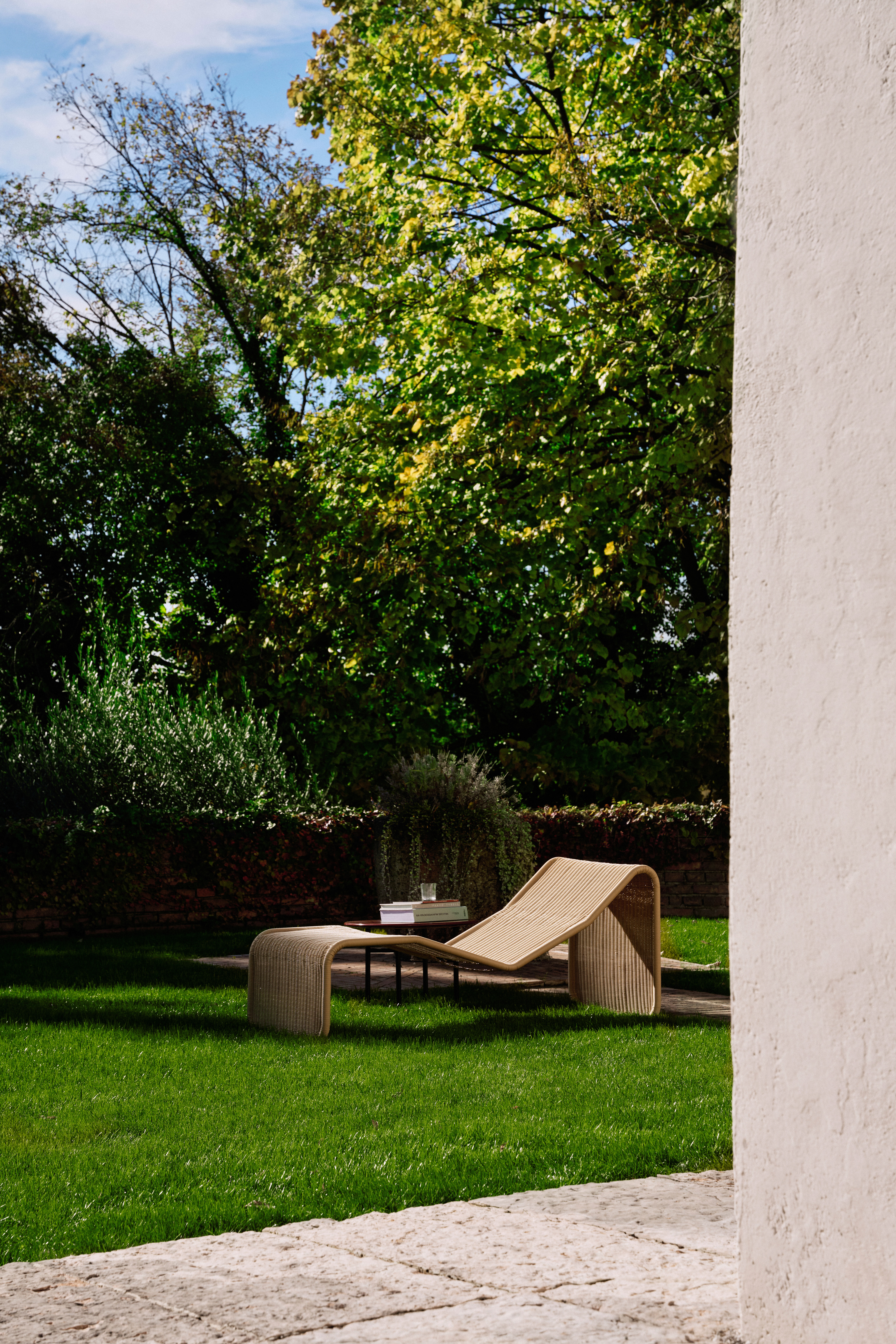 Rattan chairs by Gubi and Bonacina photographed poolside in a garden