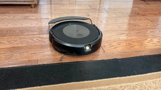 Roomba J9+ Combo robot vacuum and mop releases the onboard water tank and dust bin combined into a compact crescent shape.
