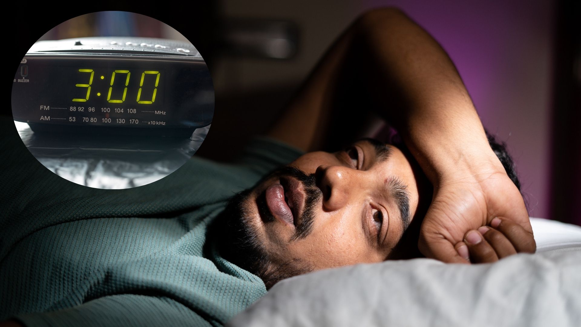 The image shows a man lying in bed with his eyes open and his arm resting on the top of his head. A digital clock beside him shows the time is 3AM