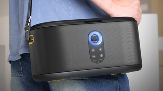 An Ikarao Shell S1 being carried over the shoulder by a person wearing blue jeans and a blue top