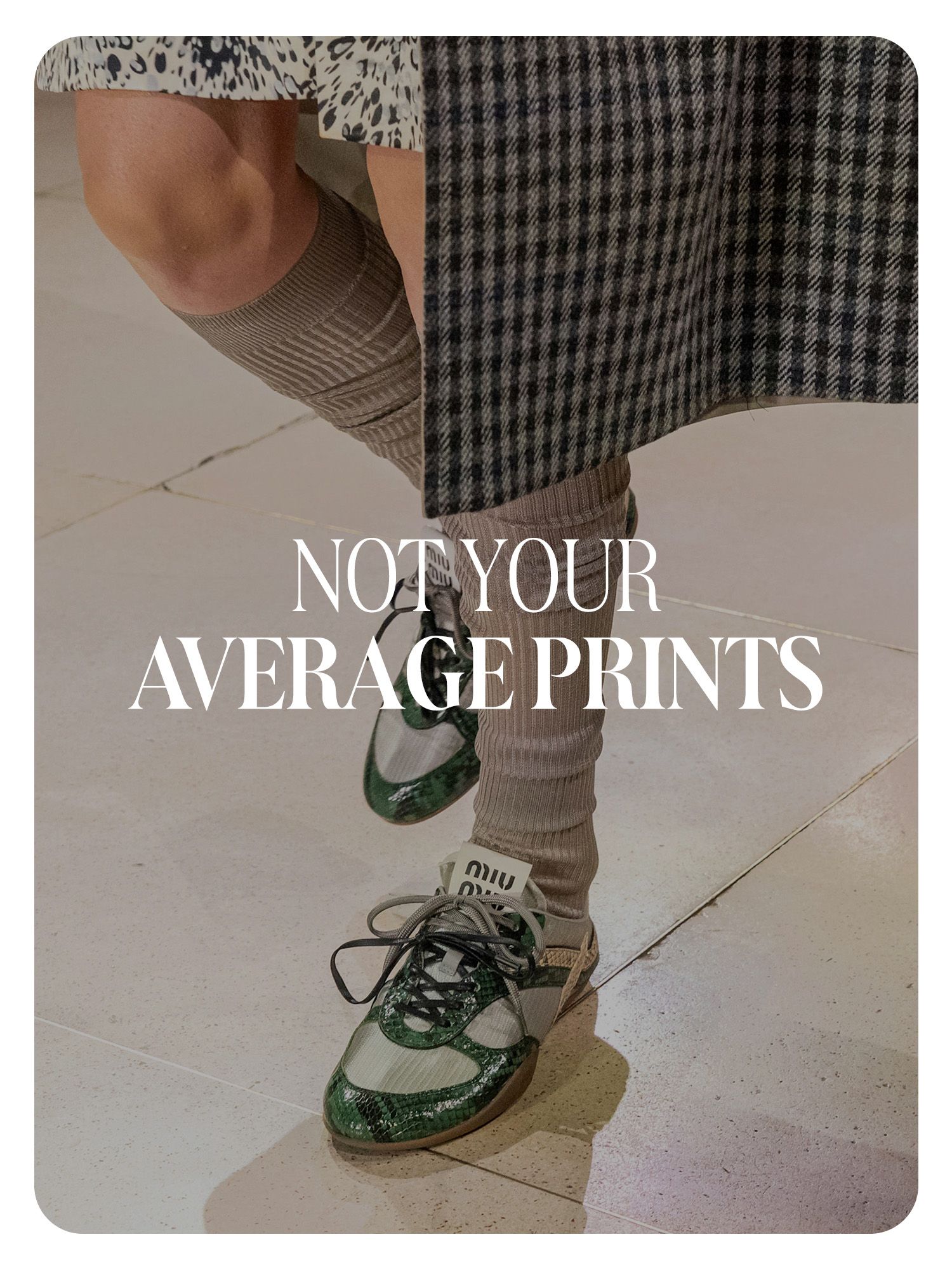 A Miu Miu model wearing a plaid coat, tall socks, and snakeskin green sneakers. Text reads, "Not Your Average Prints."