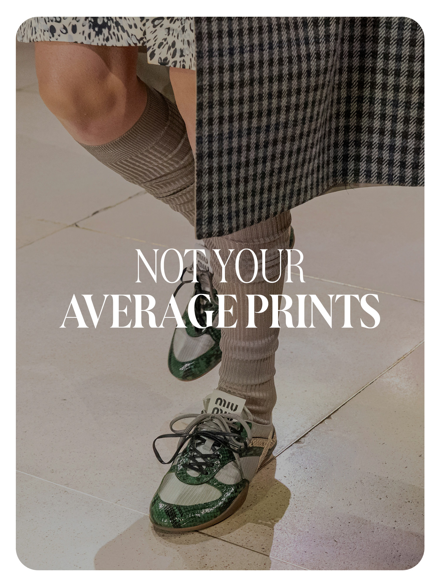 A Miu Miu model wearing a plaid coat, tall socks, and snakeskin green sneakers. Text reads, &quot;Not Your Average Prints.&quot;
